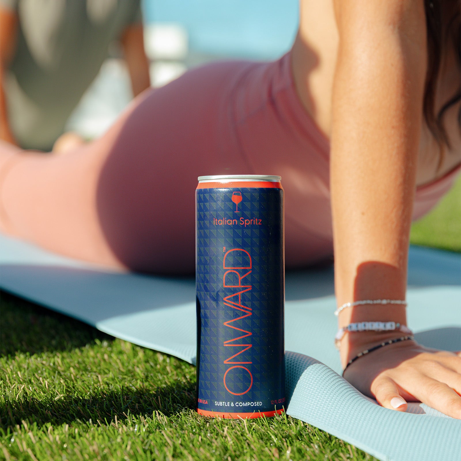 Onward Italian Spritz can on a yoga mat with a person in the background